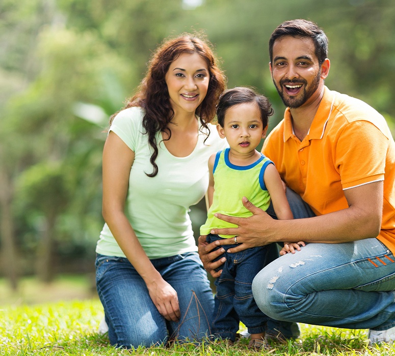 Mother father and child smiling after visiting the dental office