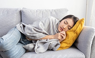 Lady sleeps on couch