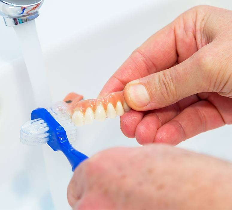 Patient caring for denture at home