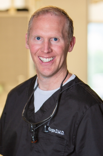 Doctor Koops smiling and wearing scrubs