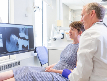 Doctor Koops talking to dental patient