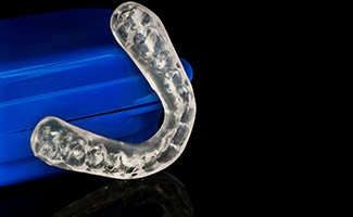 a nightguard resting against a blue protective case