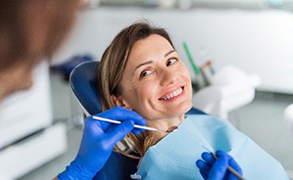 a patient having her teeth cleaned at the dental office