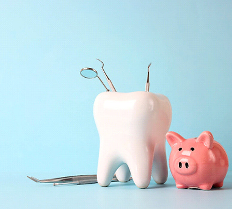 a piggy bank and tooth model with medical instruments on a blue background