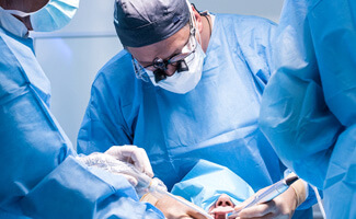 dentists performing a dental implant surgery