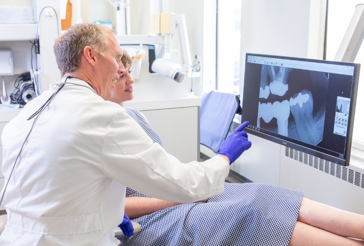 Beachwood dentist and patient looking at digital dental x rays on chairside computer