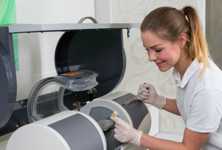 Dental team member creating a CEREC same day dental crown