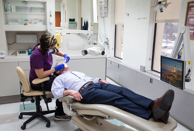 Dental team member safetly treating patient