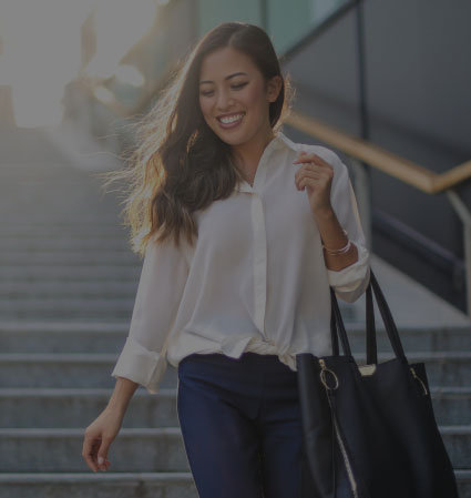 Woman in white blouse walking down outdoor staircase