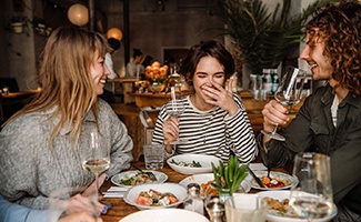 Group of friends enjoying meal together at restaurant