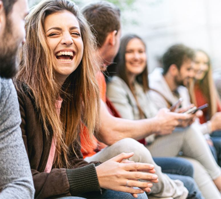 Invisalign patient in Beachwood smiling with friends