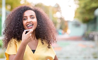 Invisalign patient in Beachwood putting in their aligners