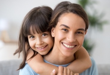 Mother and daughter smiling after children's dentistry appointment