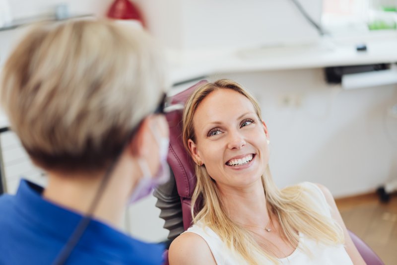 Happy woman smiling at dentist appointment