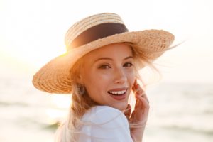 Woman enjoying the summer sun for a healthy smile