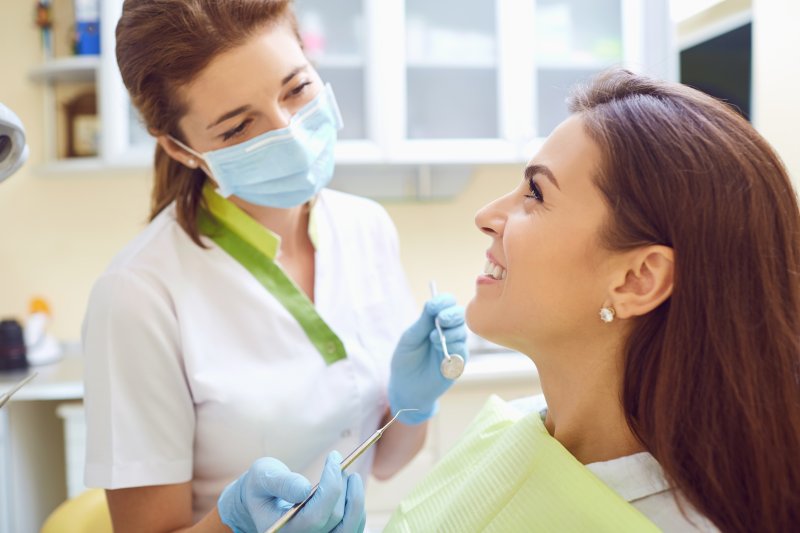 patient talking with dentist during dental checkup