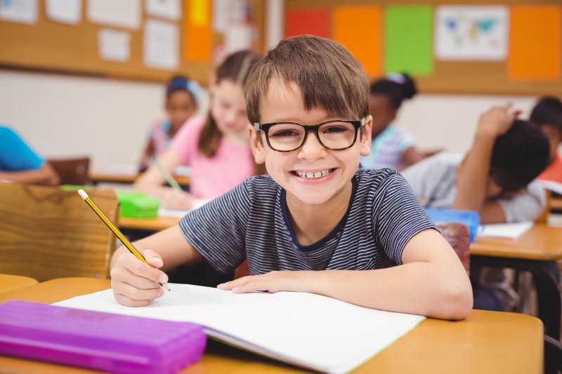 young boy smiling in school