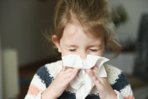 Child blowing nose 