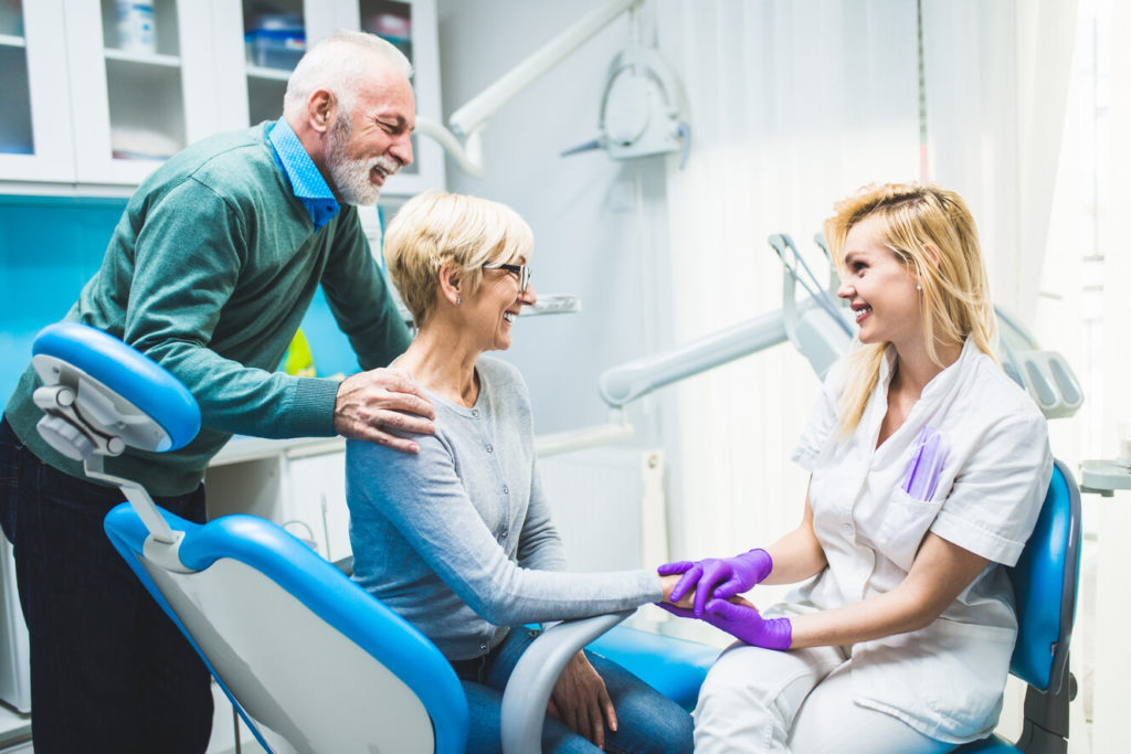 couple speaking with dentist about dental implants