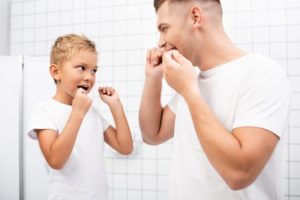 father and son flossing